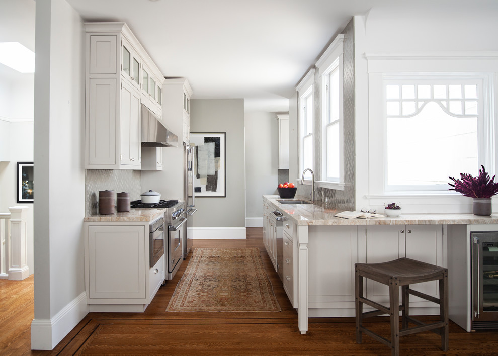 Inspiration for a classic l-shaped kitchen in San Francisco with a submerged sink, shaker cabinets, grey cabinets, grey splashback, stainless steel appliances, medium hardwood flooring, no island, brown floors and beige worktops.
