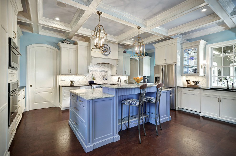 Eat-in kitchen - large coastal u-shaped cork floor eat-in kitchen idea in Charleston with recessed-panel cabinets, blue cabinets, granite countertops, white backsplash, ceramic backsplash, stainless steel appliances and an island
