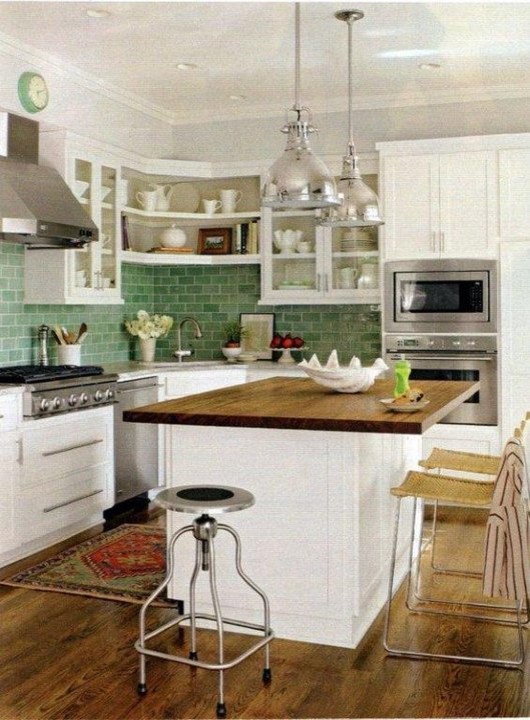 Inspiration for a small country single-wall medium tone wood floor eat-in kitchen remodel in Other with an undermount sink, shaker cabinets, white cabinets, granite countertops, green backsplash, subway tile backsplash, stainless steel appliances and an island