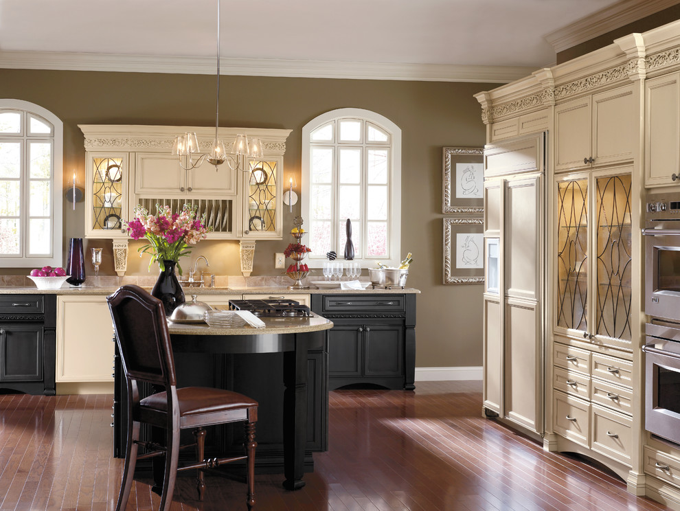 Eat-in kitchen - mid-sized traditional single-wall medium tone wood floor and brown floor eat-in kitchen idea in New York with recessed-panel cabinets, beige cabinets, paneled appliances and an island