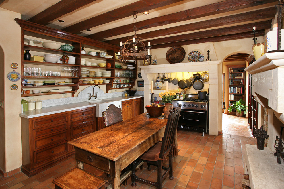 Kitchen photo in Orange County with open cabinets, dark wood cabinets, black appliances and a farmhouse sink
