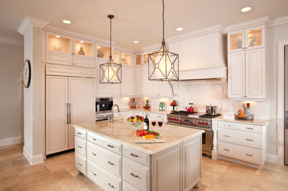 Inspiration for a classic kitchen in Tampa with glass-front cabinets and travertine flooring.