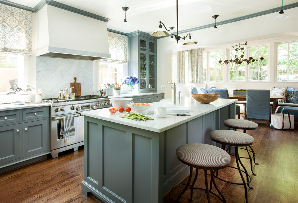 Inspiration for a classic galley kitchen in Atlanta with green cabinets, a belfast sink, recessed-panel cabinets, white splashback, stainless steel appliances, dark hardwood flooring, an island and brown floors.