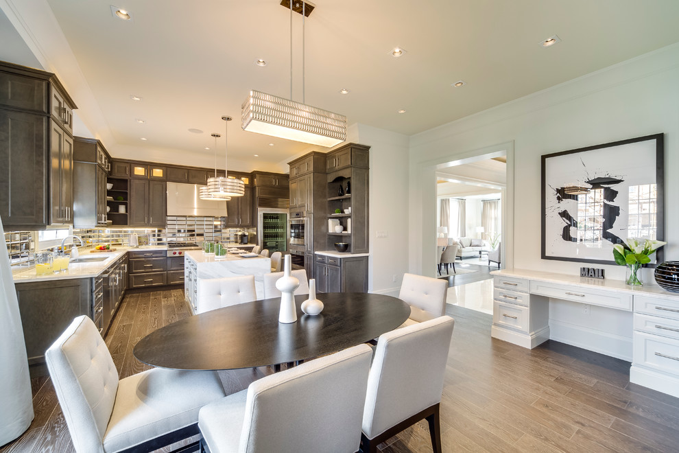 This is an example of a medium sized traditional u-shaped kitchen in Toronto with a submerged sink, recessed-panel cabinets, grey cabinets, marble worktops, stainless steel appliances, dark hardwood flooring and an island.