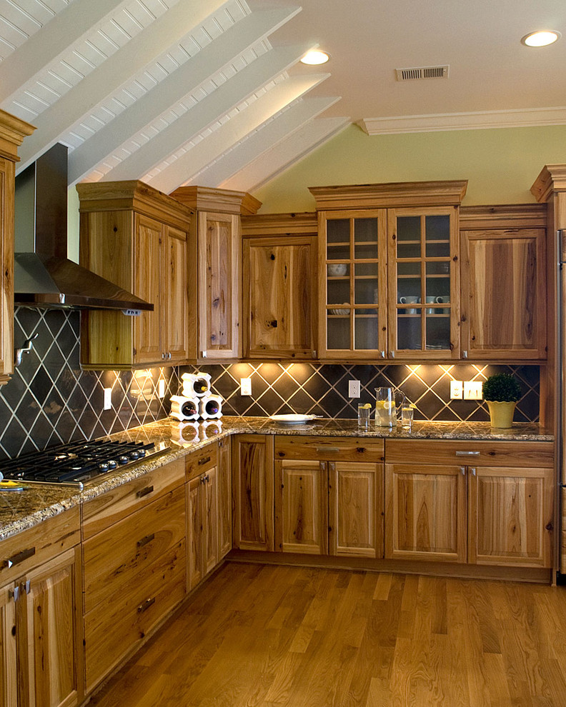 Example of a classic kitchen design in Raleigh with raised-panel cabinets, medium tone wood cabinets, granite countertops and brown backsplash