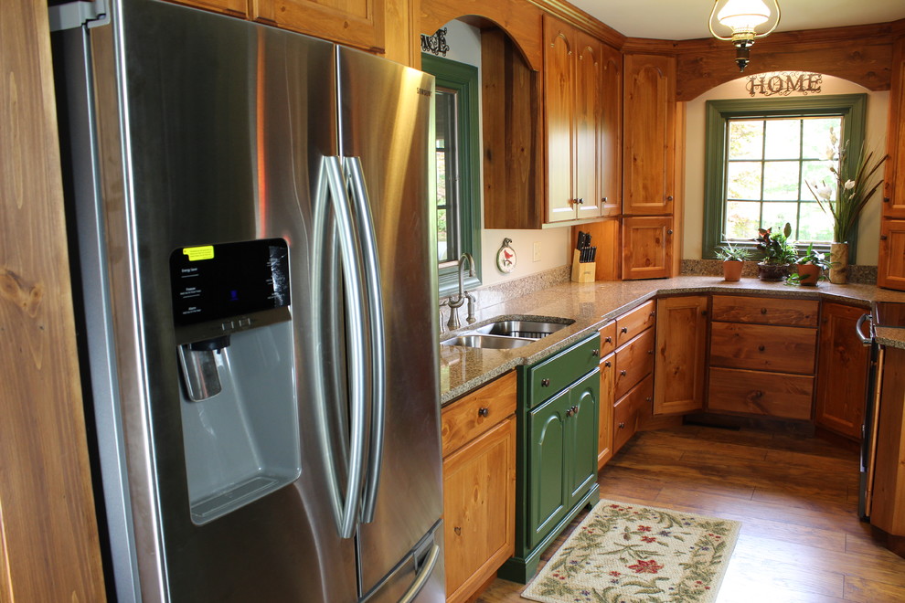 This is an example of a medium sized traditional galley enclosed kitchen in Philadelphia with a double-bowl sink, recessed-panel cabinets, medium wood cabinets, granite worktops, stainless steel appliances, medium hardwood flooring and no island.