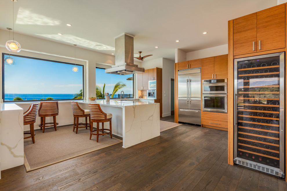Transitional u-shaped medium tone wood floor and brown floor eat-in kitchen photo in Other with an undermount sink, flat-panel cabinets, medium tone wood cabinets, stainless steel appliances and white countertops