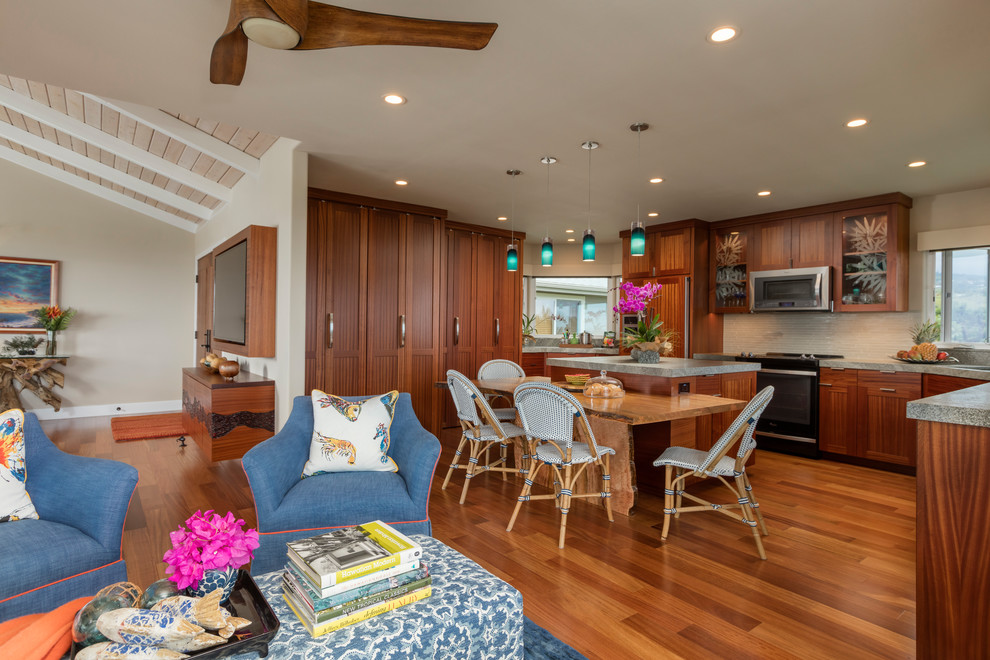 Eat-in kitchen - large tropical u-shaped dark wood floor and brown floor eat-in kitchen idea in Hawaii with a drop-in sink, flat-panel cabinets, dark wood cabinets, granite countertops, white backsplash, glass tile backsplash, stainless steel appliances and an island