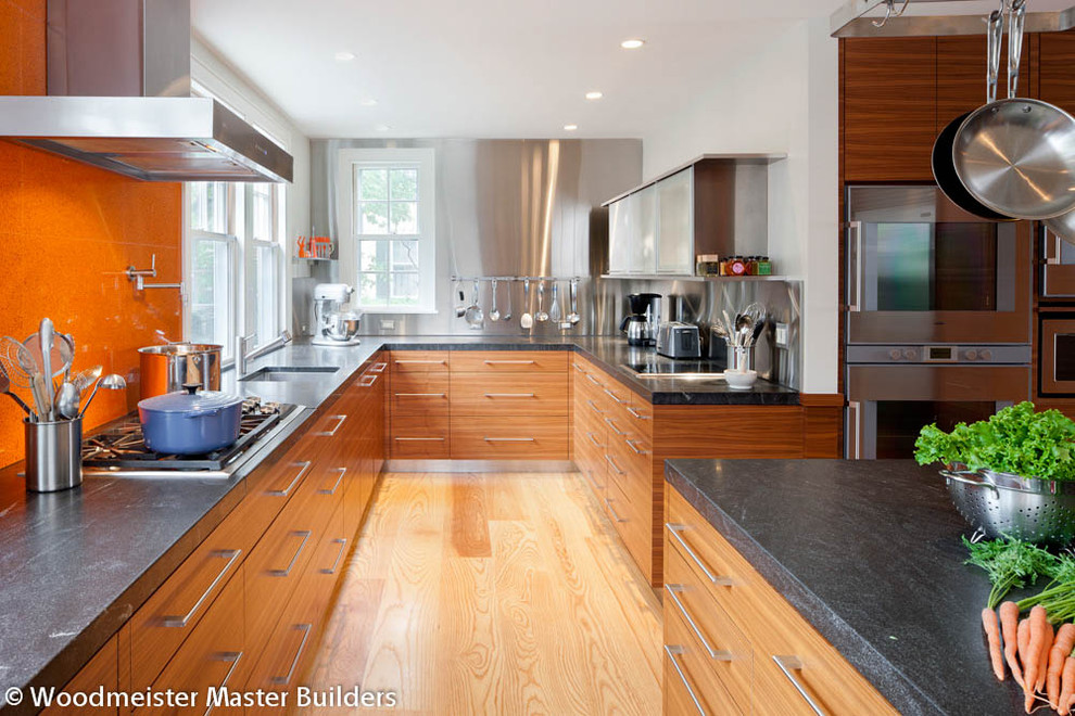 Mid-sized trendy galley light wood floor kitchen photo in Boston with flat-panel cabinets, medium tone wood cabinets, granite countertops, stainless steel appliances and an island