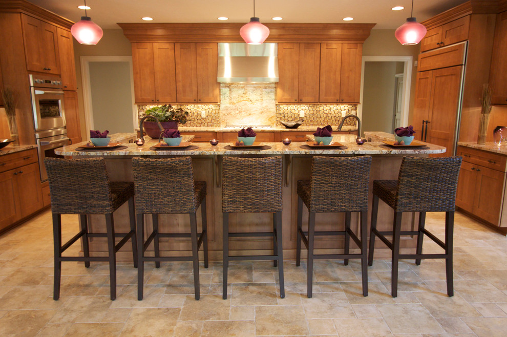 Eat-in kitchen - large traditional u-shaped ceramic tile and beige floor eat-in kitchen idea in Cleveland with an undermount sink, shaker cabinets, medium tone wood cabinets, granite countertops, beige backsplash, mosaic tile backsplash, paneled appliances and an island
