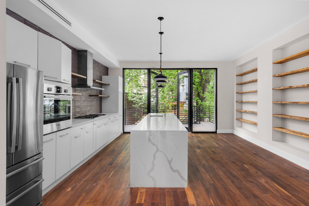 Inspiration for a small modern galley dark wood floor and brown floor eat-in kitchen remodel in New York with an undermount sink, flat-panel cabinets, white cabinets, solid surface countertops, gray backsplash, porcelain backsplash, stainless steel appliances and an island