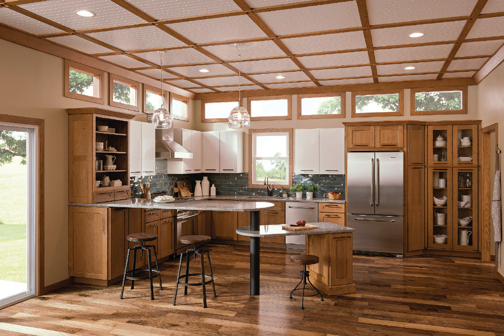 Design ideas for a medium sized traditional l-shaped kitchen/diner in Richmond with a submerged sink, shaker cabinets, medium wood cabinets, blue splashback, metro tiled splashback, stainless steel appliances, dark hardwood flooring, a breakfast bar and brown floors.