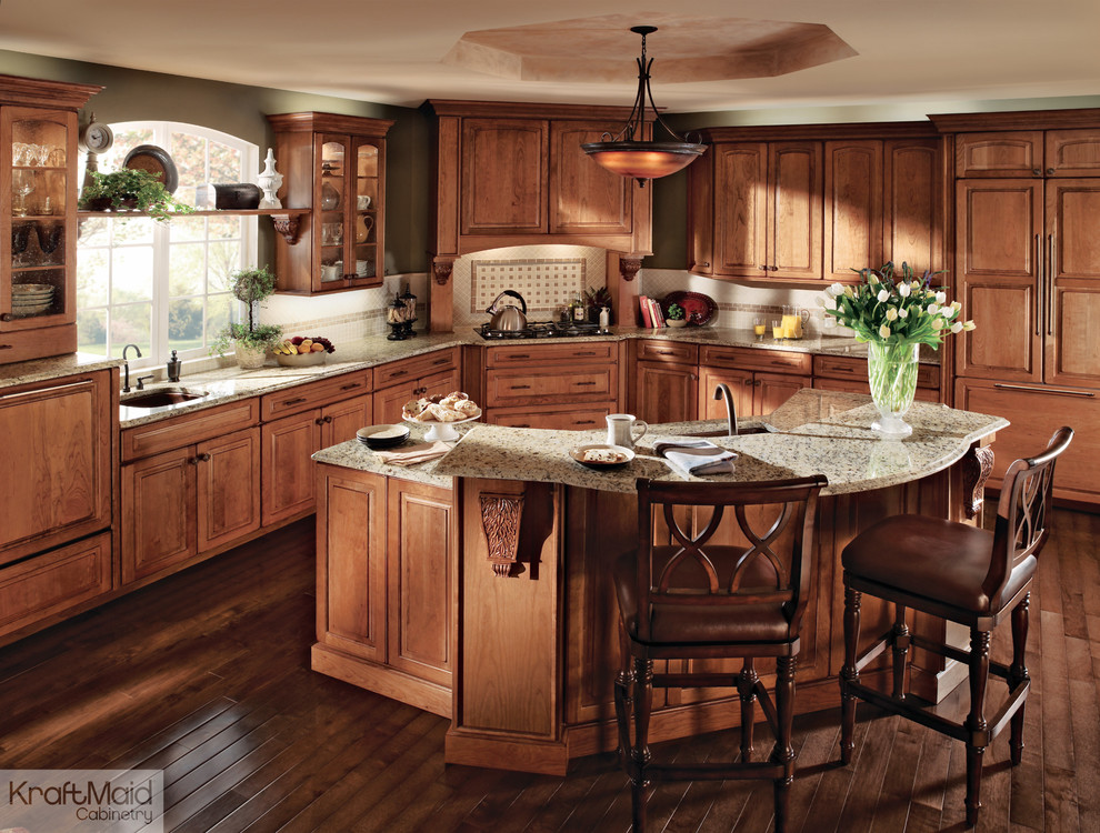 Example of a mid-sized classic l-shaped medium tone wood floor eat-in kitchen design in Detroit with raised-panel cabinets, light wood cabinets and an island