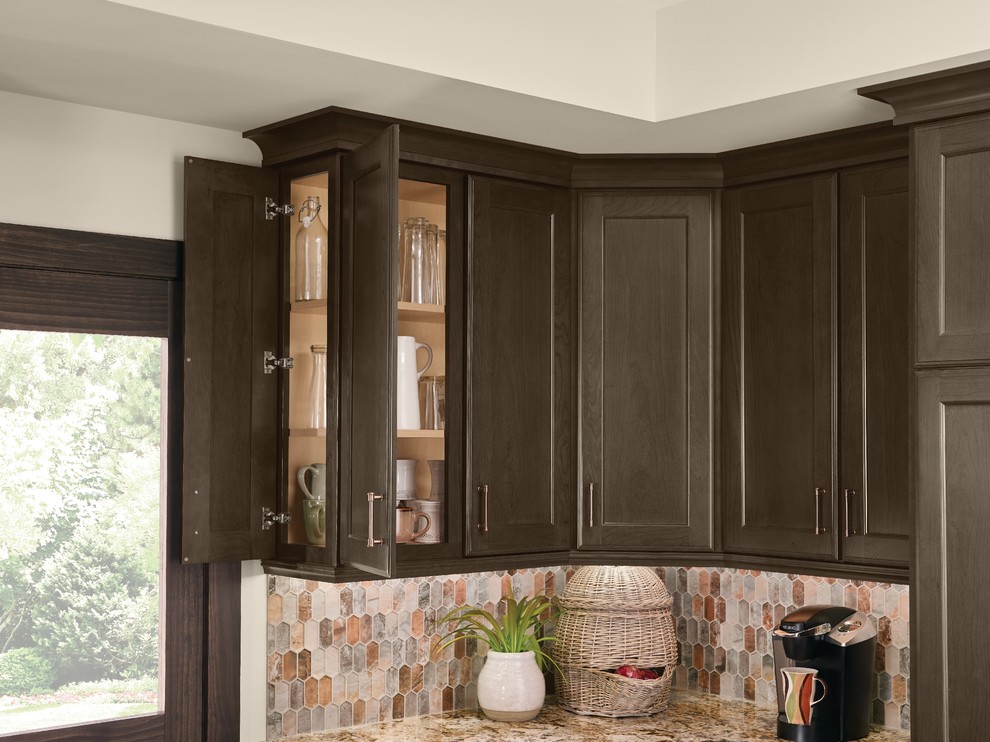 Large transitional u-shaped medium tone wood floor and brown floor open concept kitchen photo in Detroit with a double-bowl sink, recessed-panel cabinets, dark wood cabinets, granite countertops, brown backsplash, stainless steel appliances, an island and brown countertops