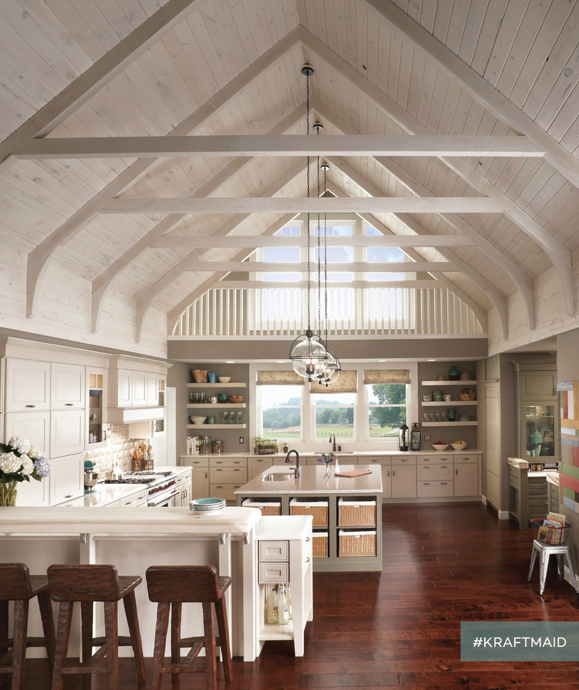 Large rural u-shaped kitchen/diner in Detroit with raised-panel cabinets, beige cabinets, stainless steel appliances, dark hardwood flooring and a breakfast bar.