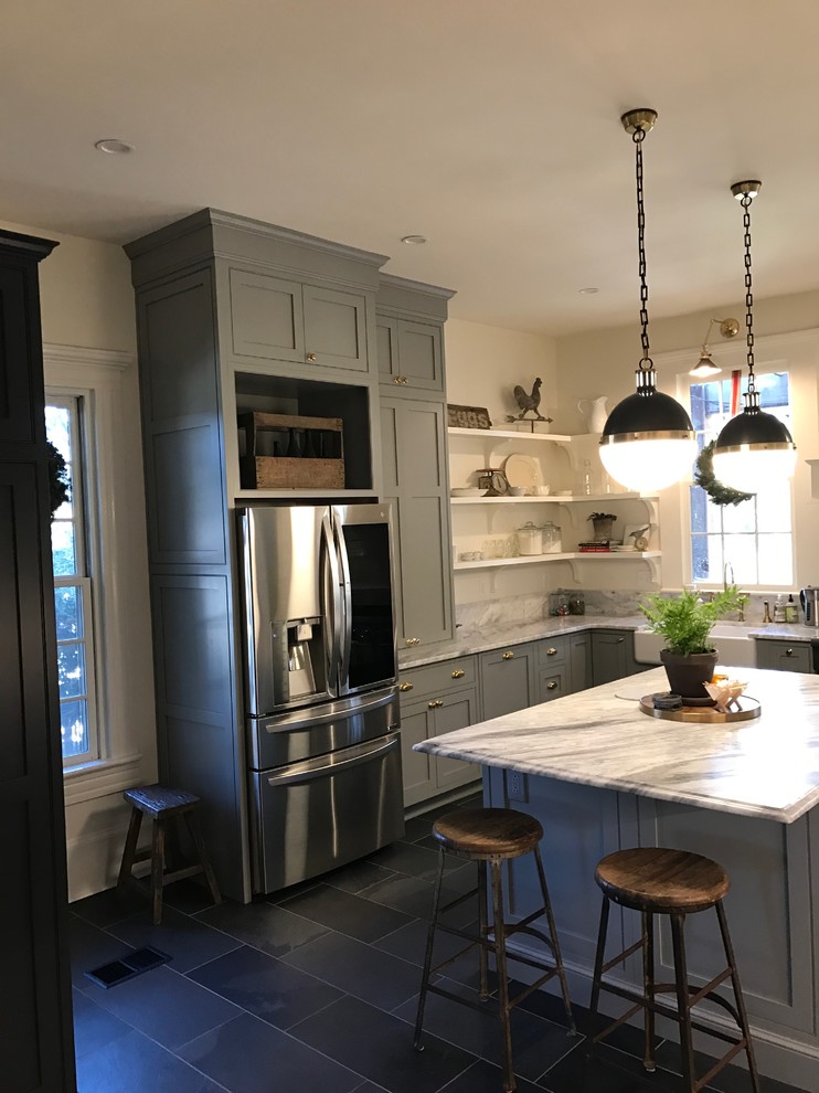 Photo of a large traditional u-shaped kitchen/diner in Atlanta with a belfast sink, shaker cabinets, grey cabinets, marble worktops, white appliances, slate flooring, an island and black floors.