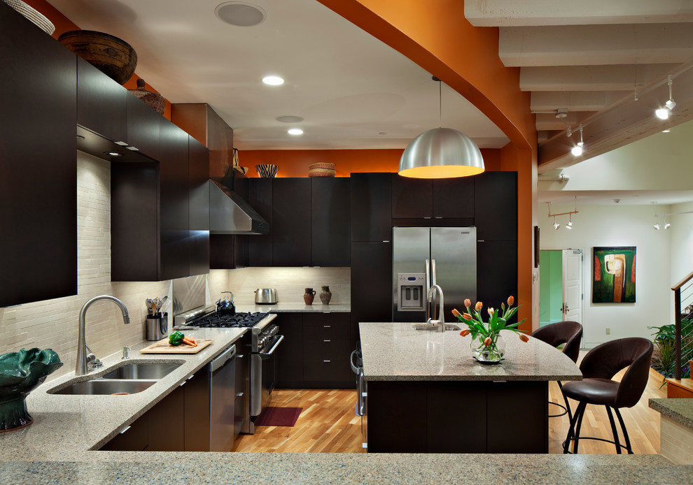 Kitchen - contemporary kitchen idea in Raleigh with a double-bowl sink, flat-panel cabinets, black cabinets, white backsplash and stainless steel appliances