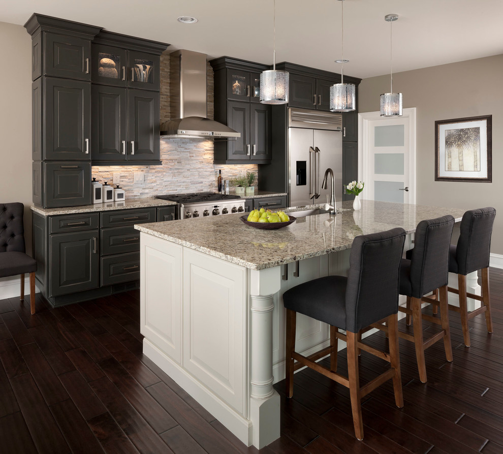 Inspiration for a large transitional galley dark wood floor kitchen remodel in Other with an undermount sink, raised-panel cabinets, gray cabinets, matchstick tile backsplash, stainless steel appliances, beige backsplash, an island and quartz countertops