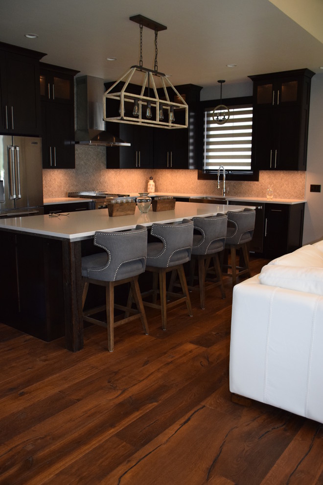 Photo of a medium sized modern l-shaped kitchen/diner in Other with a submerged sink, stainless steel appliances, medium hardwood flooring, dark wood cabinets, granite worktops, shaker cabinets and an island.