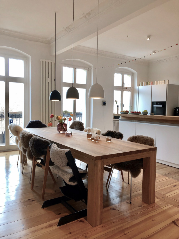 Inspiration for a large contemporary kitchen/dining room in Berlin with light hardwood flooring and brown floors.