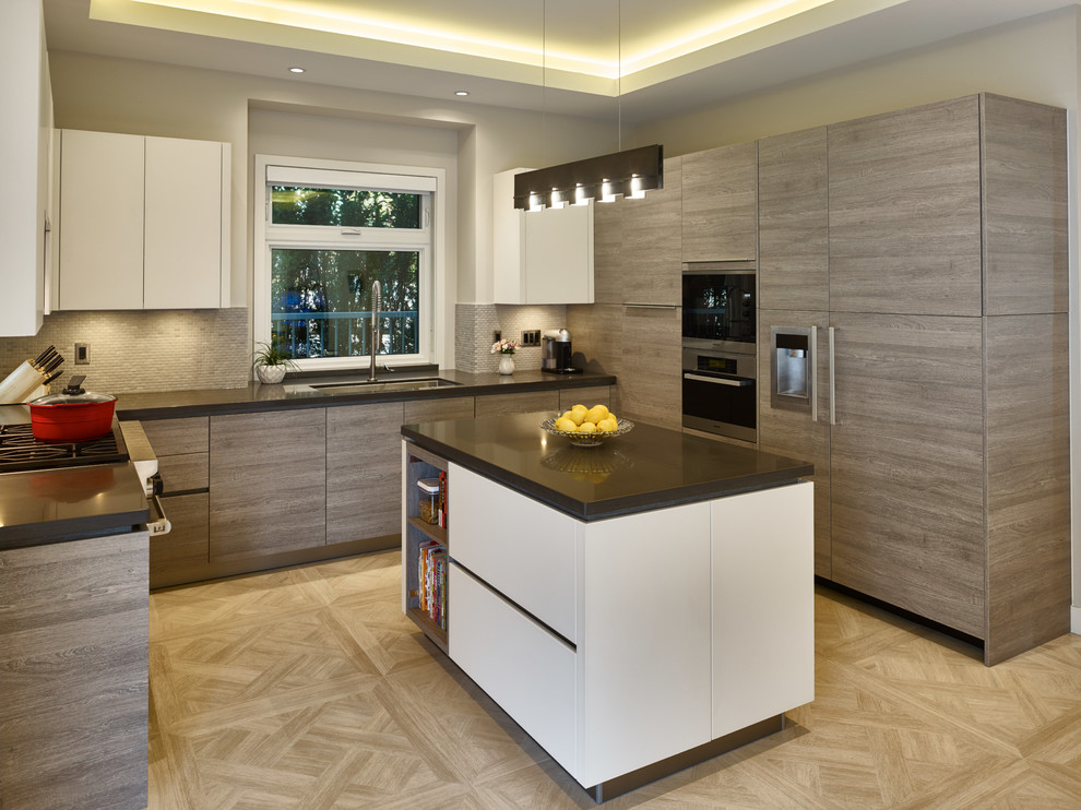 Example of a mid-sized trendy u-shaped porcelain tile eat-in kitchen design in Vancouver with an undermount sink, flat-panel cabinets, light wood cabinets, granite countertops, gray backsplash, stone tile backsplash, stainless steel appliances and an island