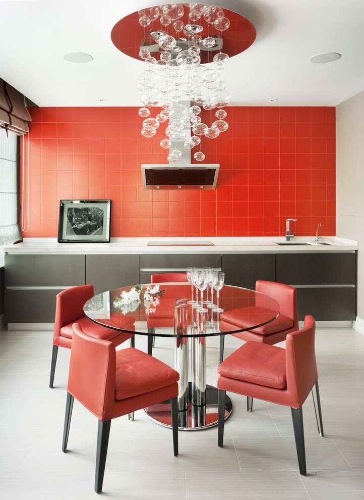 Photo of a contemporary single-wall enclosed kitchen in Moscow with a submerged sink, flat-panel cabinets, black cabinets, red splashback, ceramic splashback, no island and stainless steel appliances.