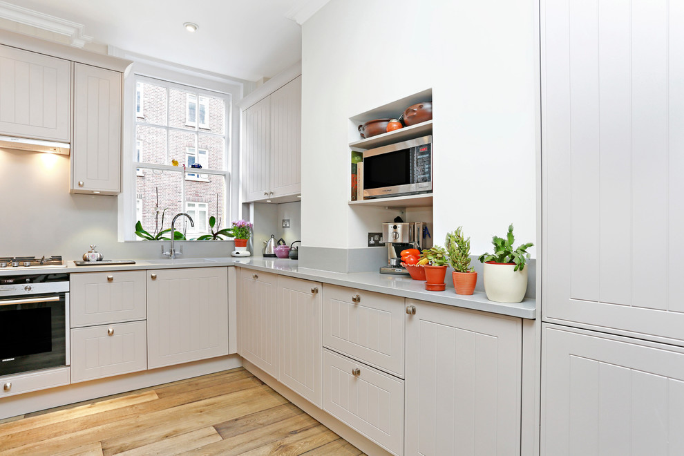 This is an example of a traditional grey and cream kitchen in London.