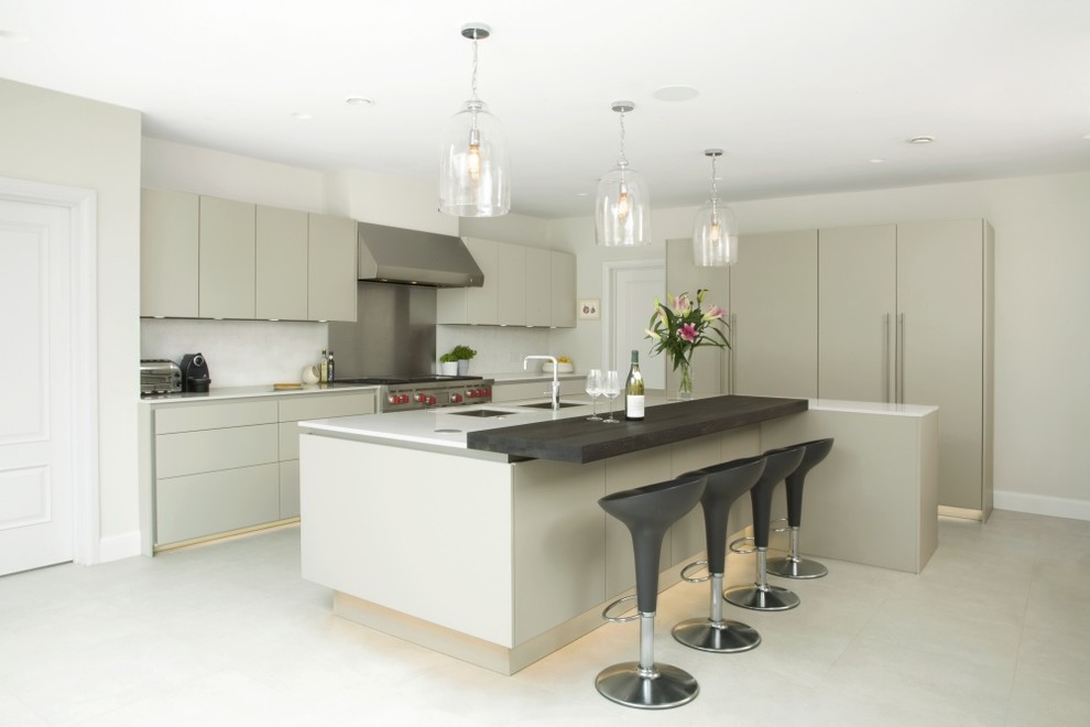 Large contemporary u-shaped kitchen/diner in Hertfordshire with a double-bowl sink, flat-panel cabinets, grey cabinets, quartz worktops, white splashback, stone slab splashback, stainless steel appliances, ceramic flooring, an island, white floors and white worktops.