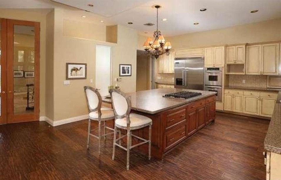 This is an example of a large kitchen/diner in Los Angeles with shaker cabinets, granite worktops and an island.
