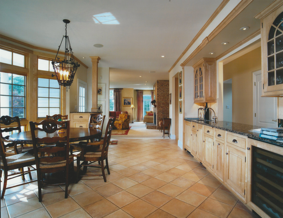 Large tuscan porcelain tile eat-in kitchen photo in New York with an undermount sink, raised-panel cabinets, light wood cabinets, granite countertops, beige backsplash, terra-cotta backsplash, paneled appliances and an island