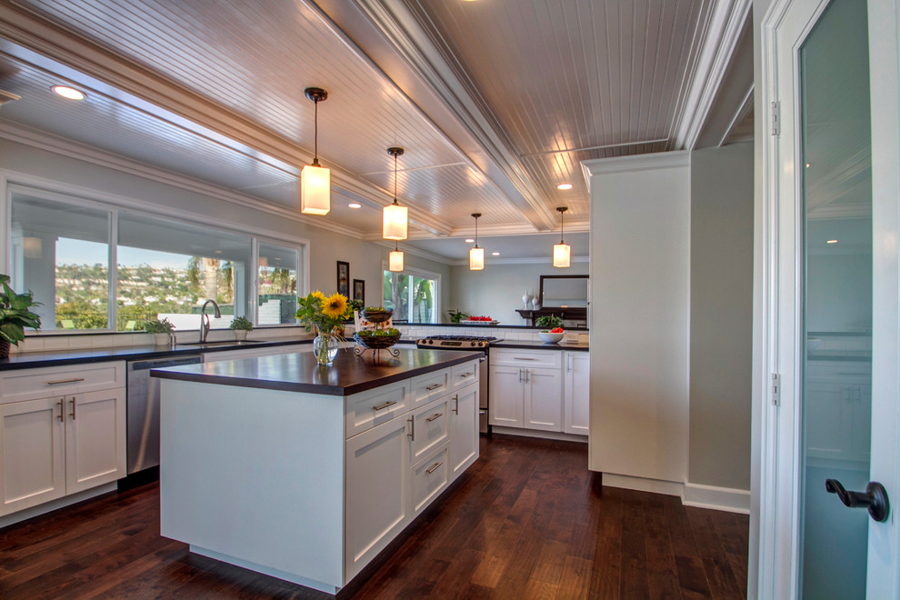 Large elegant l-shaped dark wood floor eat-in kitchen photo in Orange County with a drop-in sink, recessed-panel cabinets, white cabinets, stainless steel appliances and an island