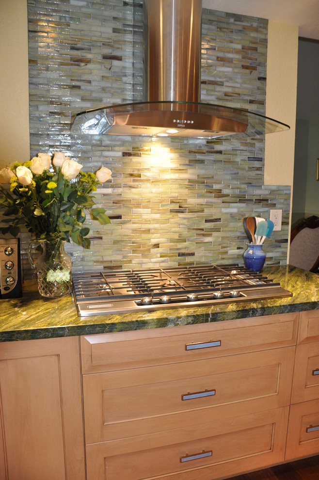 This is an example of a contemporary kitchen in San Diego with medium wood cabinets and green splashback.