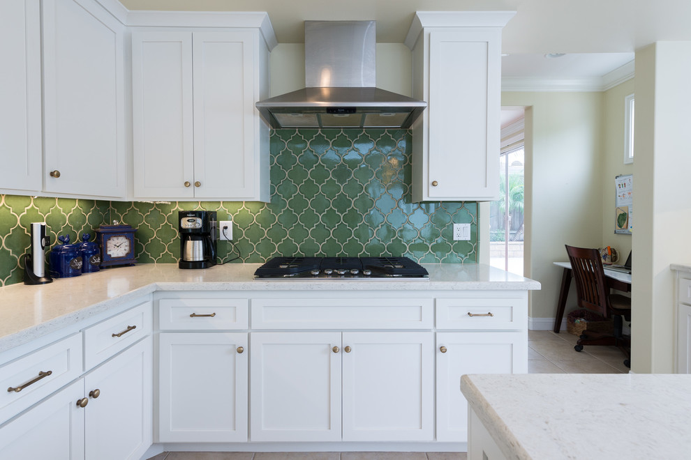 Kitchen - craftsman porcelain tile kitchen idea in San Diego with a single-bowl sink, shaker cabinets, white cabinets, quartz countertops, green backsplash, ceramic backsplash, stainless steel appliances and an island