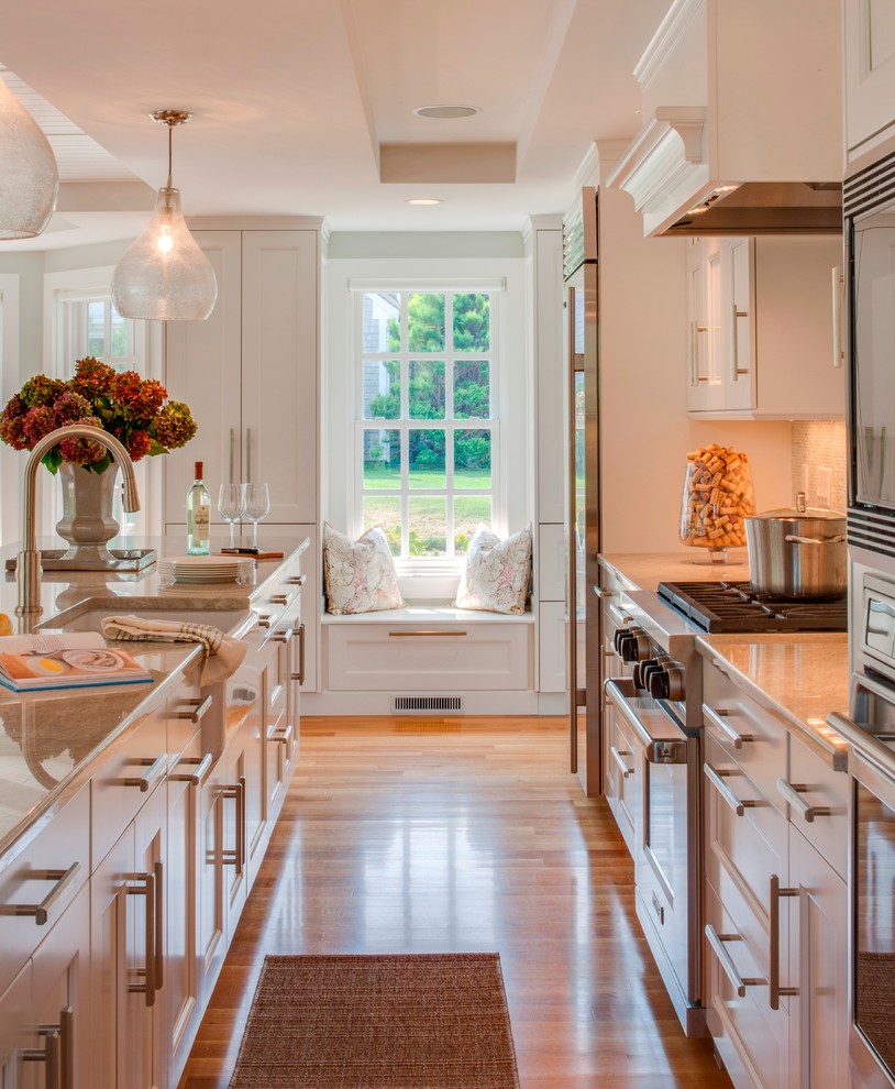 Example of a beach style kitchen design in Boston with shaker cabinets