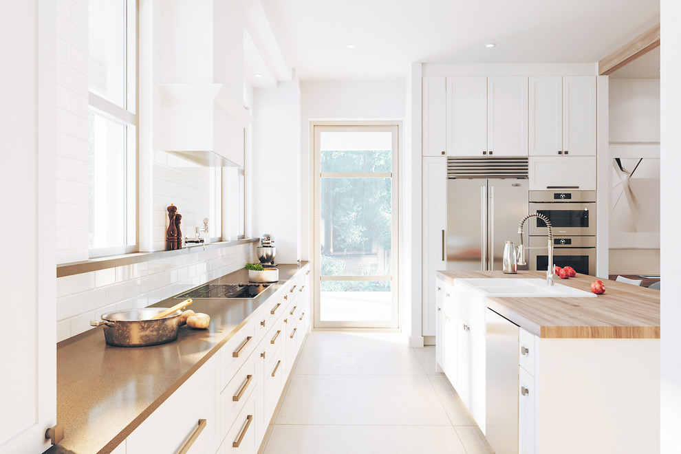 Photo of a contemporary l-shaped kitchen in Montreal with a belfast sink, shaker cabinets, white cabinets, white splashback, metro tiled splashback, stainless steel appliances, an island, beige floors and brown worktops.
