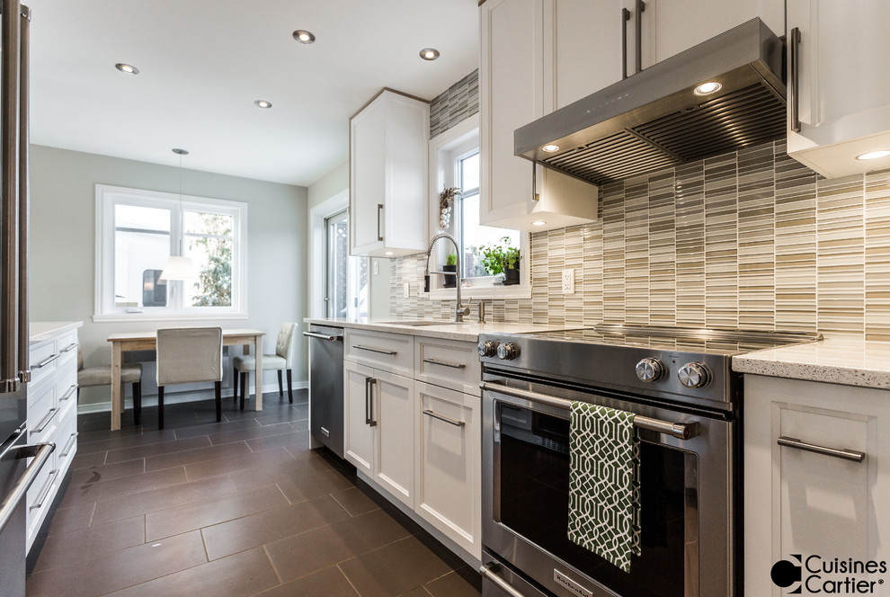 Example of a small danish galley ceramic tile enclosed kitchen design in Montreal with an undermount sink, shaker cabinets, white cabinets, quartzite countertops, gray backsplash, glass tile backsplash, stainless steel appliances and no island
