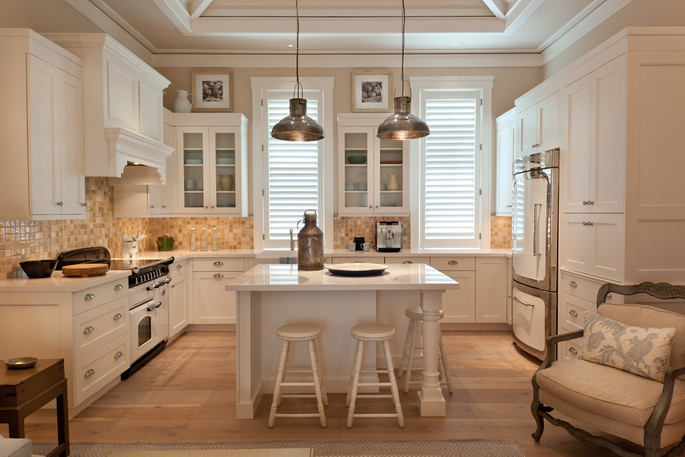 Kitchen - traditional u-shaped kitchen idea in Miami with shaker cabinets, white cabinets, beige backsplash and white appliances