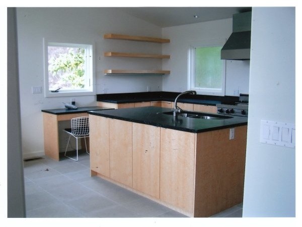 Small modern u-shaped kitchen in Denver with a double-bowl sink, flat-panel cabinets, light wood cabinets, soapstone worktops, grey splashback, stone slab splashback, stainless steel appliances, porcelain flooring and an island.