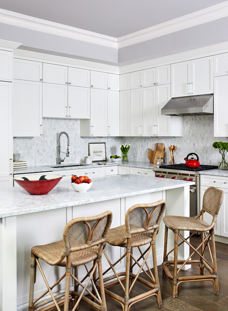 Eat-in kitchen - traditional l-shaped medium tone wood floor and brown floor eat-in kitchen idea in Los Angeles with an undermount sink, recessed-panel cabinets, white cabinets, gray backsplash, mosaic tile backsplash, stainless steel appliances, an island and gray countertops