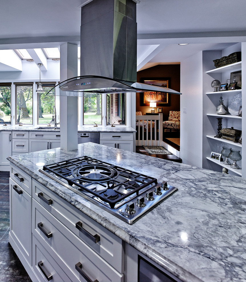 Inspiration for a modern u-shaped eat-in kitchen remodel in Philadelphia with an undermount sink, shaker cabinets, white cabinets, quartzite countertops, multicolored backsplash and stainless steel appliances