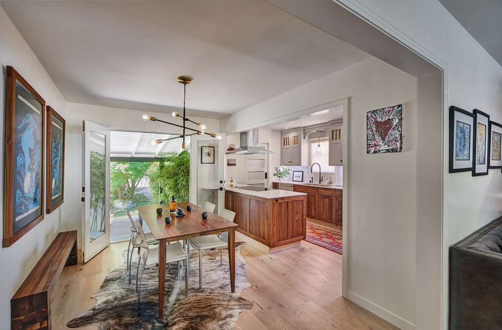 Medium sized eclectic galley kitchen/diner in Sacramento with a submerged sink, shaker cabinets, medium wood cabinets, engineered stone countertops, white splashback, porcelain splashback, stainless steel appliances, light hardwood flooring, a breakfast bar, multi-coloured floors and white worktops.