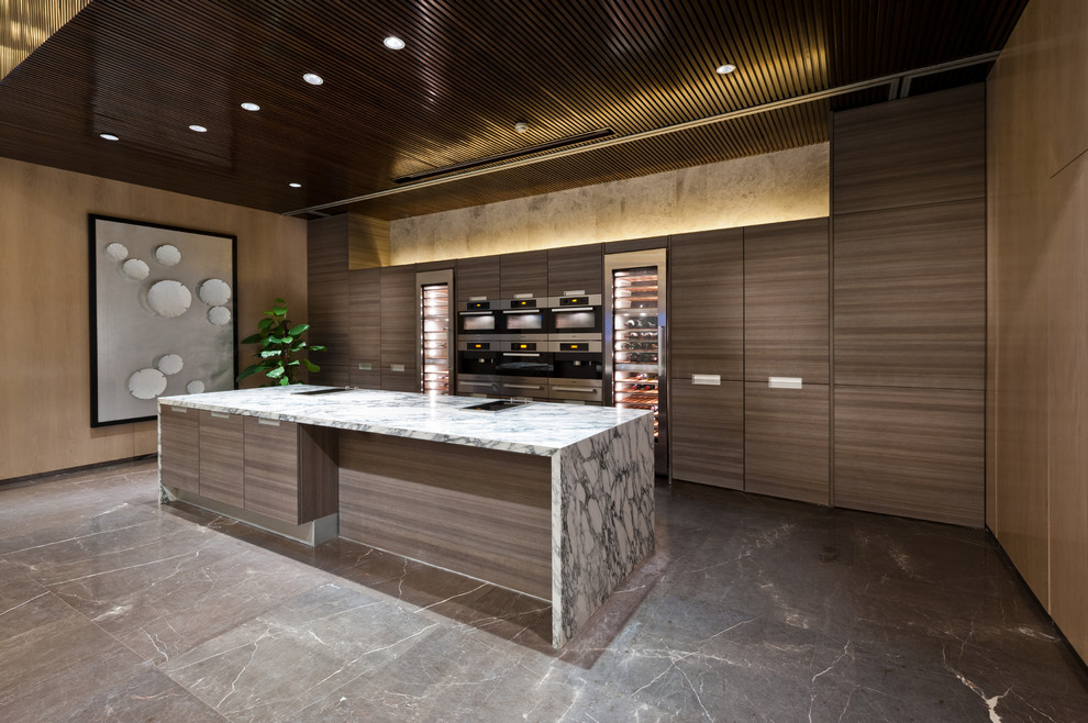 Eat-in kitchen - large contemporary single-wall marble floor eat-in kitchen idea in Orange County with an undermount sink, flat-panel cabinets, medium tone wood cabinets, marble countertops, stainless steel appliances and an island