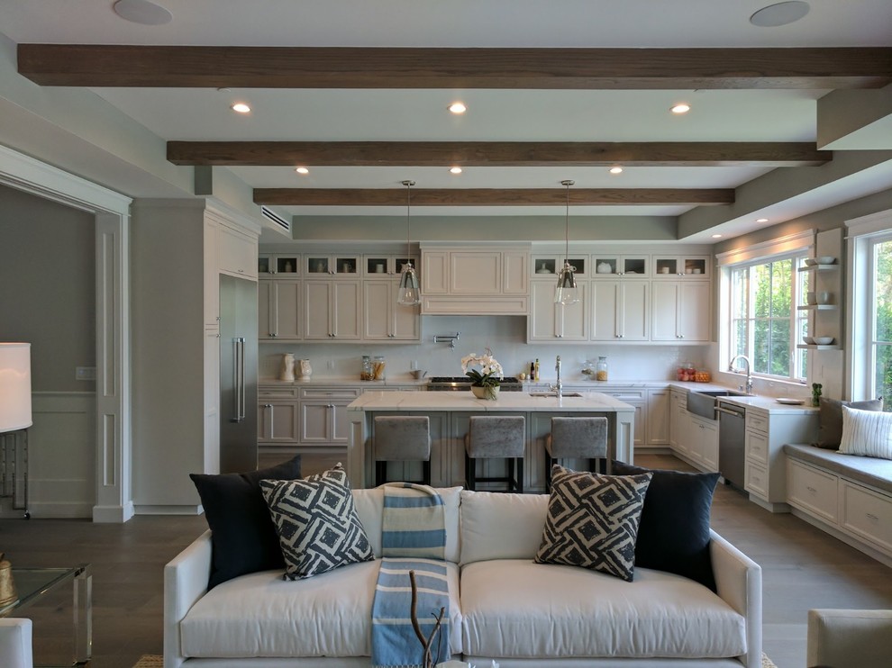 Inspiration for a large modern u-shaped porcelain tile, gray floor and exposed beam eat-in kitchen remodel in Orange County with an undermount sink, recessed-panel cabinets, white cabinets, quartz countertops, white backsplash, stone slab backsplash, stainless steel appliances, an island and white countertops