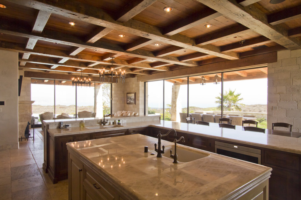 Large tuscan u-shaped ceramic tile open concept kitchen photo in Santa Barbara with raised-panel cabinets, dark wood cabinets, marble countertops, an island, an undermount sink, beige backsplash, ceramic backsplash and stainless steel appliances