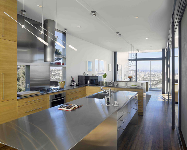 Example of a minimalist kitchen design in San Francisco with stainless steel countertops and stainless steel appliances