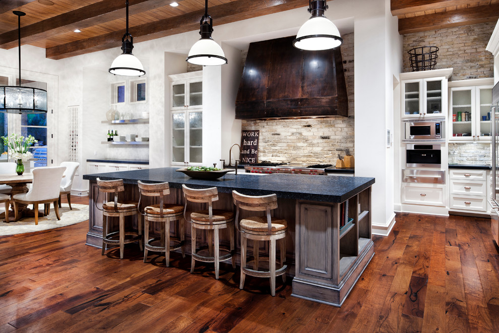 Eat-in kitchen - traditional eat-in kitchen idea in Houston with shaker cabinets, white cabinets, multicolored backsplash and stainless steel appliances
