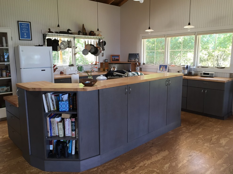 Large beach style l-shaped cork floor eat-in kitchen photo in Burlington with flat-panel cabinets, black cabinets, wood countertops, white backsplash, wood backsplash, white appliances and an island