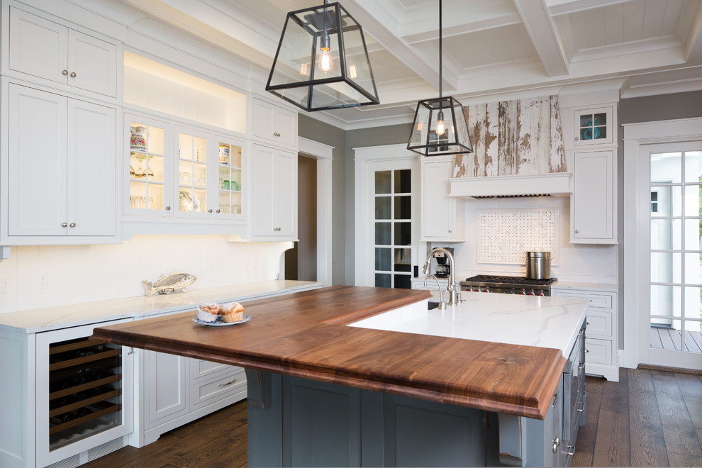 Inspiration for a large transitional l-shaped medium tone wood floor and brown floor kitchen remodel in Other with shaker cabinets, white cabinets, stainless steel appliances and an island