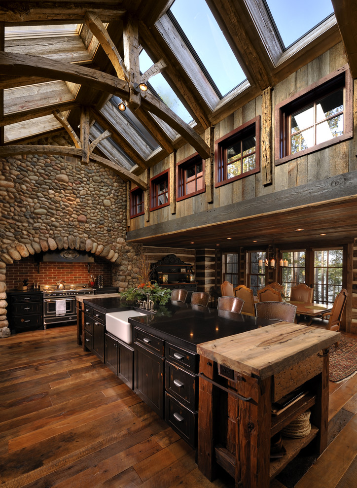 Inspiration for a rustic eat-in kitchen remodel in Minneapolis with a farmhouse sink, recessed-panel cabinets, distressed cabinets and black appliances