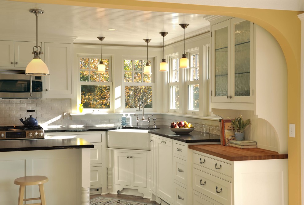 Example of a classic kitchen design in Minneapolis with subway tile backsplash, a farmhouse sink, beaded inset cabinets, white cabinets and white backsplash